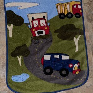 Kids gently used  fleece blanket with truck design.